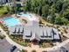 Aerial view of the community pool and clubhouse, featuring a large pool, kiddie pool, and plenty of lounge chairs at 423 Sensibility Cir, Fort Mill, SC 29708