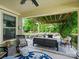 Inviting covered patio with comfortable seating, a ceiling fan, and a view of the beautifully landscaped backyard at 423 Sensibility Cir, Fort Mill, SC 29708