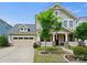 Charming two-story home with a well-maintained front yard, a covered porch, and an attached two-car garage at 423 Sensibility Cir, Fort Mill, SC 29708