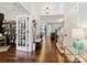 Open foyer with hardwood floors and views into the living spaces, accented by a stylish bench and decor at 423 Sensibility Cir, Fort Mill, SC 29708