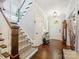 Bright foyer with hardwood floors, a staircase with patterned carpet, and decorative lighting at 423 Sensibility Cir, Fort Mill, SC 29708