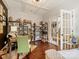 Bright and organized home office featuring custom shelving, natural light, and hardwood floors at 423 Sensibility Cir, Fort Mill, SC 29708
