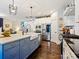 Well-appointed kitchen featuring a farmhouse sink, modern appliances, and hardwood floors at 423 Sensibility Cir, Fort Mill, SC 29708