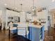 Spacious kitchen with a central island, white countertops, and stylish pendant lights at 423 Sensibility Cir, Fort Mill, SC 29708