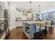 Modern kitchen featuring white cabinets, stainless steel appliances, and an island with pendant lighting at 423 Sensibility Cir, Fort Mill, SC 29708