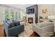 Comfortable living room with a fireplace, shiplap wall, a flat screen TV, and plenty of seating at 423 Sensibility Cir, Fort Mill, SC 29708