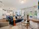 Bright living room featuring hardwood floors, a comfortable sectional, and an open layout to the kitchen and backyard at 423 Sensibility Cir, Fort Mill, SC 29708