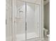 Luxurious marble tiled shower features a rainfall shower head and glass door at 423 Sensibility Cir, Fort Mill, SC 29708