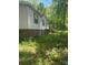 Exterior view of home with white siding, brick foundation, and overgrown lawn at 433 E Geroid St, Salisbury, NC 28144