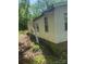 Exterior view of a single story home with damaged siding and overgrown lawn at 433 E Geroid St, Salisbury, NC 28144