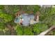 Aerial view of a home featuring a sparkling pool, lush landscaping, and mature trees at 4525 Island Waters Dr, Denver, NC 28037