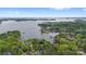Scenic aerial view of a lake surrounded by lush greenery, waterfront homes, and boat docks at 4525 Island Waters Dr, Denver, NC 28037