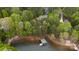 Aerial view showcases a lakefront home surrounded by mature trees and a private dock at 4525 Island Waters Dr, Denver, NC 28037
