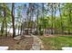 Lush backyard with stone path leading to a firepit and the waterfront at 4525 Island Waters Dr, Denver, NC 28037