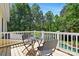 Outdoor balcony featuring a table and chairs, overlooking lush greenery and trees at 4525 Island Waters Dr, Denver, NC 28037