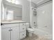 Clean bathroom features a white vanity, toilet, tub, and coordinated hardware at 4525 Island Waters Dr, Denver, NC 28037