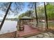 Private covered dock with seating area and boat slips on the waterfront at 4525 Island Waters Dr, Denver, NC 28037
