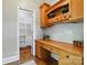 This home office features custom wood cabinetry, a spacious desk, and a walk-in pantry for added storage at 4525 Island Waters Dr, Denver, NC 28037