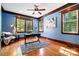 Spacious home office with refinished wood floors, striking blue walls, and dark wood trim at 4525 Island Waters Dr, Denver, NC 28037