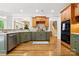 Stylish kitchen featuring green cabinets, modern appliances, and hardwood floors at 4525 Island Waters Dr, Denver, NC 28037
