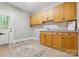 Well-equipped laundry room with ample cabinet space, sink, and an exterior door for convenience at 4525 Island Waters Dr, Denver, NC 28037