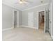 Bright main bedroom features white trim, plush carpet and a ceiling fan at 4525 Island Waters Dr, Denver, NC 28037