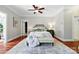 Bright main bedroom with neutral tones and features a seating area, tray, and access to a walk-in closet at 4525 Island Waters Dr, Denver, NC 28037