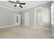 Spacious main bedroom boasts a ceiling fan and multiple entryways for easy access to other rooms at 4525 Island Waters Dr, Denver, NC 28037