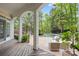 Inviting covered patio with wicker furniture overlooking a pristine pool and landscaped backyard at 4525 Island Waters Dr, Denver, NC 28037