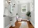 Classic powder room features pedestal sink, updated fixtures, and a window offering natural light at 4525 Island Waters Dr, Denver, NC 28037