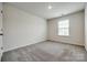 A carpeted bedroom provides a window for natural lighting and comfortable living at 5014 Fandango Rd, York, SC 29745