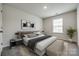 Serene bedroom boasts natural light, a modern bed frame, stylish decor, and neutral tones for a peaceful ambiance at 5014 Fandango Rd, York, SC 29745