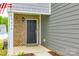 Close up of the front brick-accented entrance and dark front door, including the house number at 5014 Fandango Rd, York, SC 29745