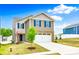 Two-story home featuring a brick-accented front, garage, blue shutters, and green front lawn at 5014 Fandango Rd, York, SC 29745