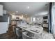 Open-concept living space flows into a dining area with a sleek kitchen featuring modern appliances and bar seating at 5014 Fandango Rd, York, SC 29745