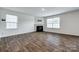 Cozy living room featuring a fireplace, natural lighting, and luxury vinyl flooring at 5014 Fandango Rd, York, SC 29745