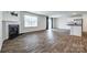 Open-concept living room with fireplace, luxury vinyl flooring and sliding glass door at 5014 Fandango Rd, York, SC 29745