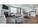 Bright living room featuring a fireplace, modern furnishings, and seamless flow to dining and kitchen areas at 5014 Fandango Rd, York, SC 29745