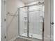 Bright shower with tiled floor, glass doors and built-in shelving at 5014 Fandango Rd, York, SC 29745