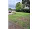 Large, grassy backyard with storage shed and mature trees for outdoor living and recreation at 51 Kings Dr, Taylorsville, NC 28681
