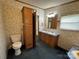 Bathroom featuring a toilet, a vanity with sink and a tall wooden cabinet at 51 Kings Dr, Taylorsville, NC 28681