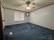 Comfortable bedroom with a large window, standard ceiling fan, and neutral walls at 51 Kings Dr, Taylorsville, NC 28681