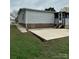 Exterior view of home showcasing the back porch, yard, and convenient concrete patio at 51 Kings Dr, Taylorsville, NC 28681