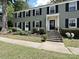 Charming gray brick two-story townhome with black shutters and a beautifully landscaped front yard at 557 Wakefield Dr # A, Charlotte, NC 28209