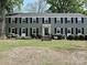 Charming brick home with black shutters, manicured landscaping, and inviting entrance at 557 Wakefield Dr # A, Charlotte, NC 28209