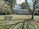 Inviting two-story townhome with gray brick, black shutters, and a large front lawn at 557 Wakefield Dr # A, Charlotte, NC 28209