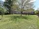 Expansive green lawn and mature trees highlight this property's curb appeal and outdoor space at 557 Wakefield Dr # A, Charlotte, NC 28209