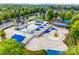 Aerial view of the community pool and splashpad featuring ample lounge seating and shade at 5716 Langwell Ln, Charlotte, NC 28278