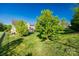 Spacious backyard with lush green grass and mature trees at 5716 Langwell Ln, Charlotte, NC 28278