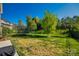 Well-maintained backyard with a trampoline and mature trees at 5716 Langwell Ln, Charlotte, NC 28278